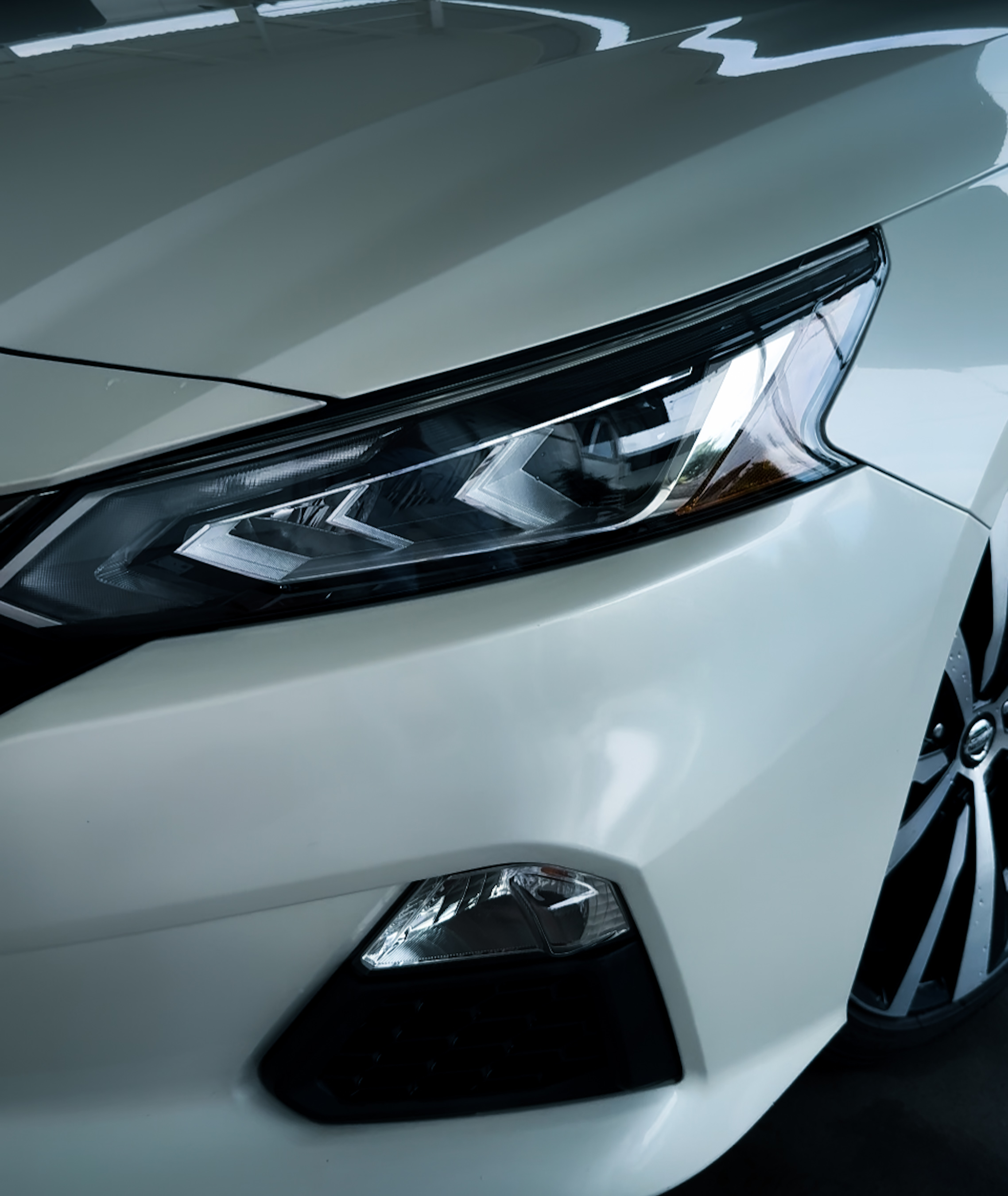 Detailed white Nissan front and headlight